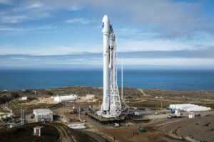 Rocket waiting on launch pad with a partly cloudy background